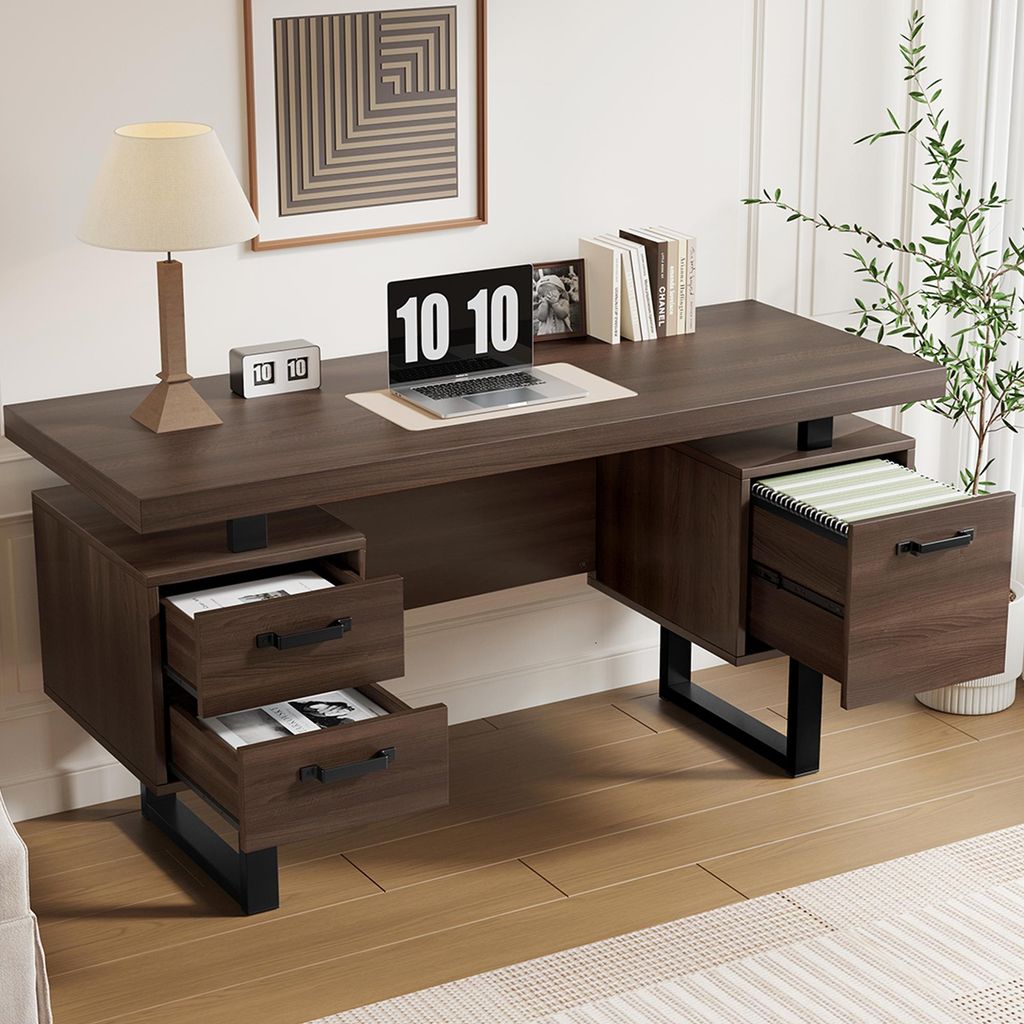 A modern office desk setup with a laptop, lamp, and books.