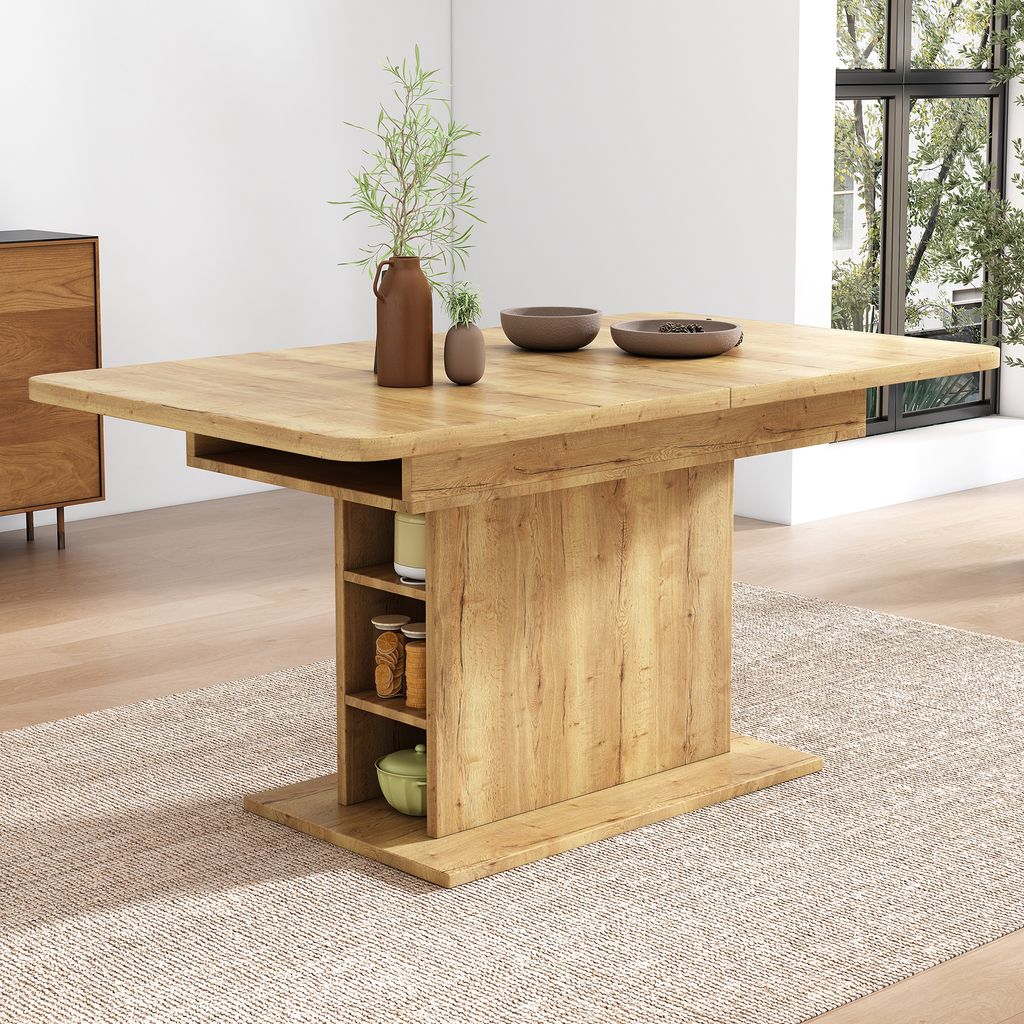 A wooden dining table with storage shelves is shown in a well-lit room with a large window and a rug.