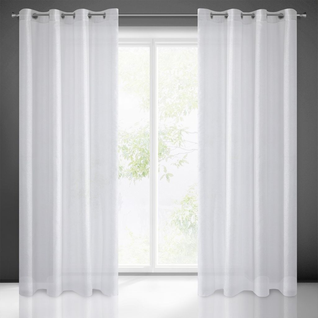 A pair of white sheer curtains hanging in front of a window.