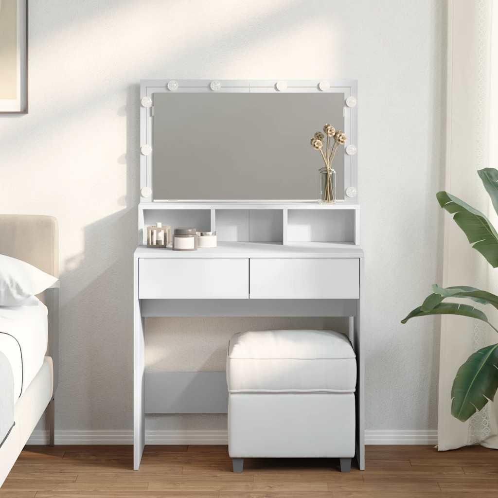 A white makeup vanity with a lighted mirror and stool, placed in a bedroom setting.