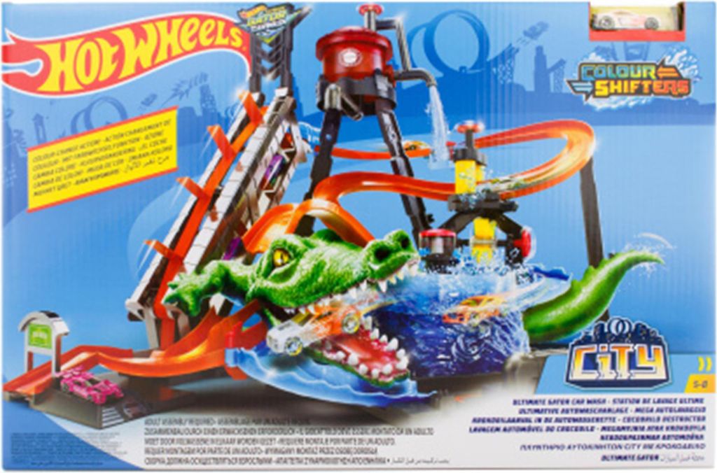 A toy car wash playset with a large green alligator as the main feature, with cars going through the wash.