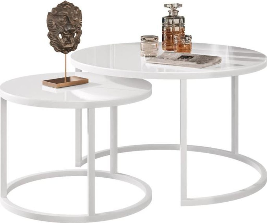 A set of two white nesting coffee tables with a decorative lion head sculpture on the smaller table and a decanter and glasses on the larger table.