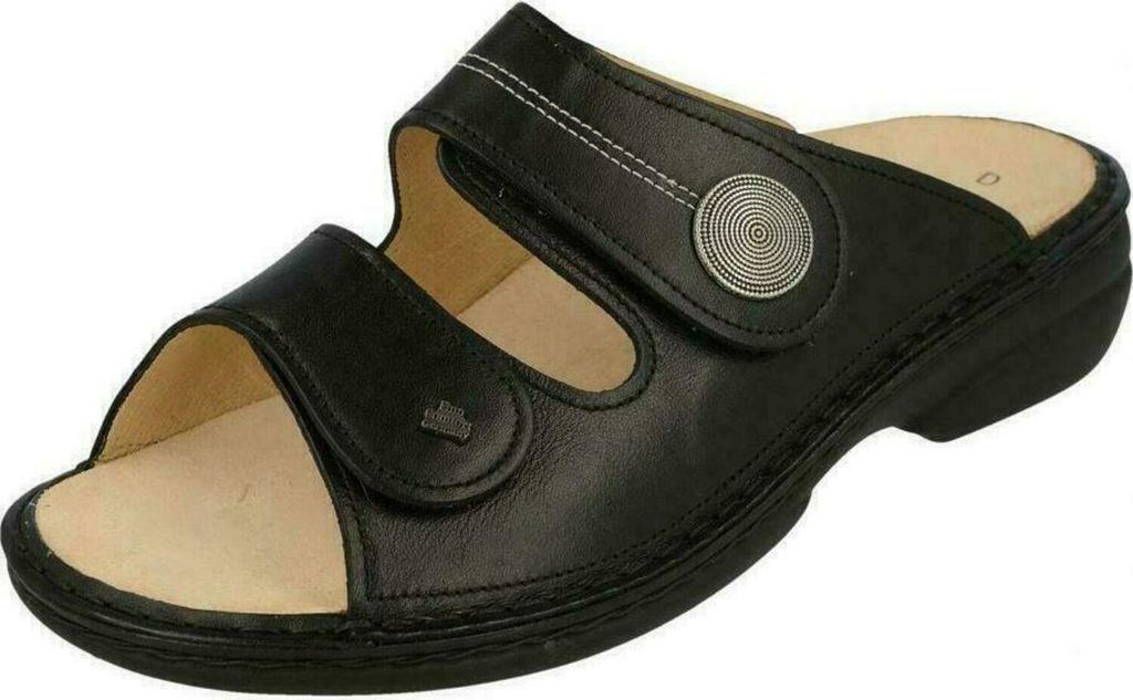 A black leather sandal is shown from a side-angle against a white background.