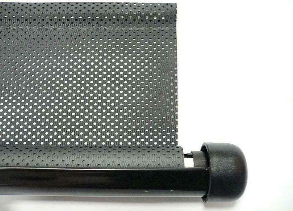 A close-up of a black roller blind with a perforated pattern, attached to a black rod with a black end cap.
