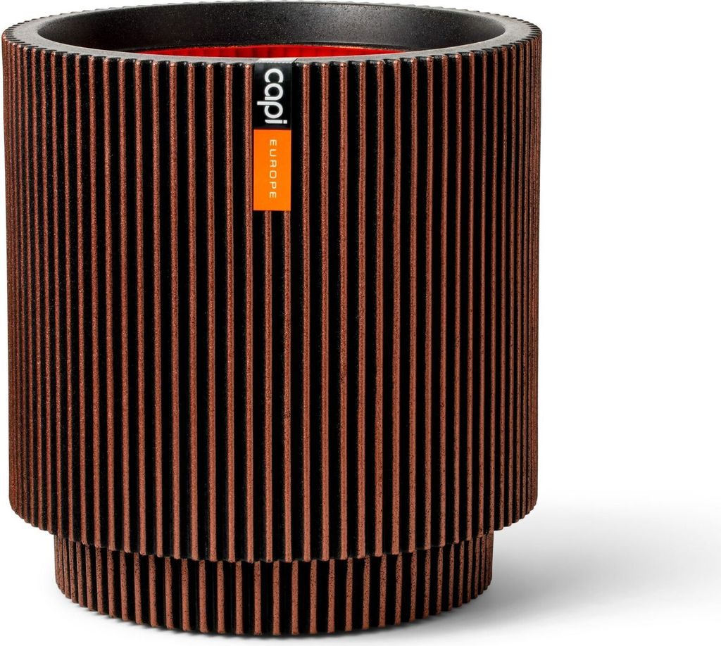 A cylindrical planter with a ribbed texture and a label.