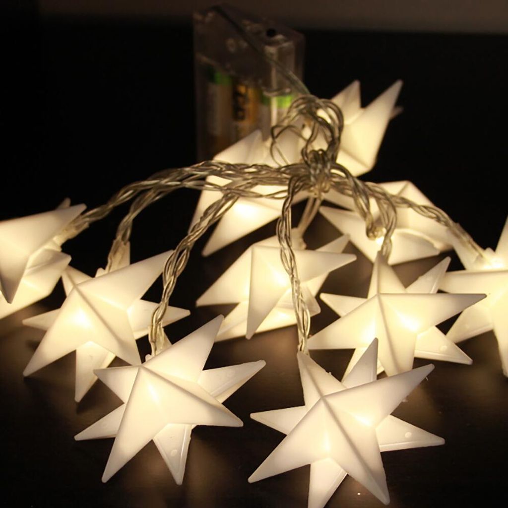 A string of white star-shaped LED lights with a battery pack in the background.