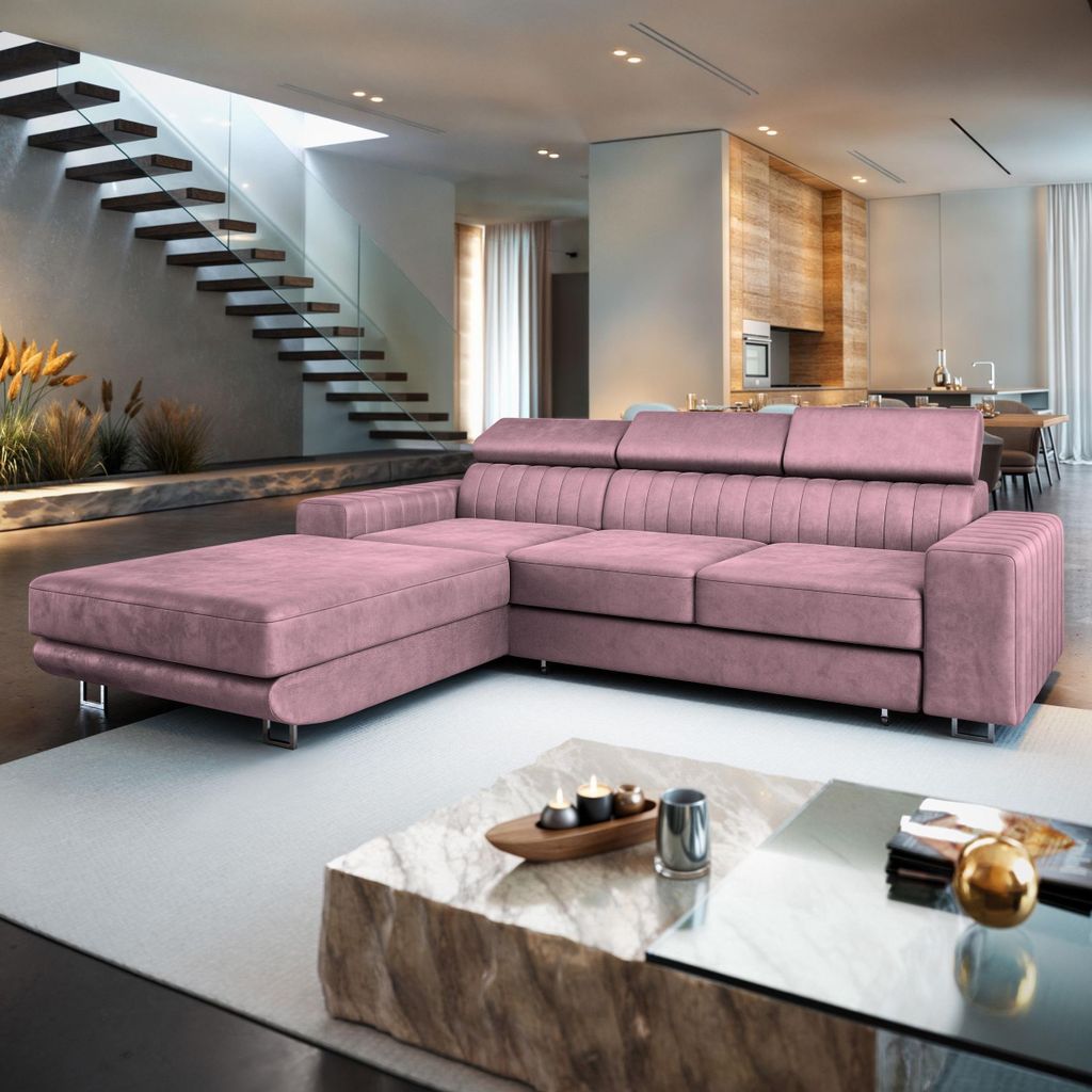 A modern living room with a pink sectional sofa, a marble coffee table, and a staircase in the background.