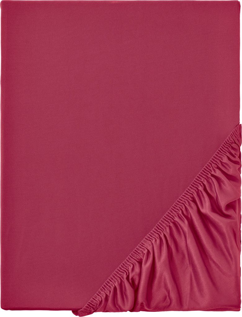 A close-up of a folded red fitted sheet, showing the elasticated edge.