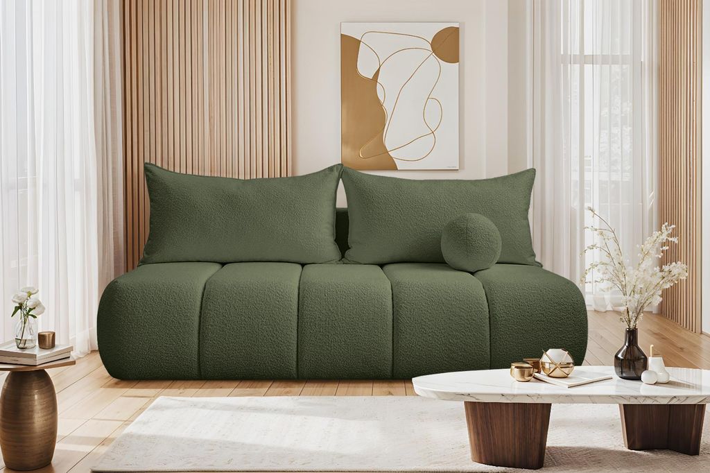 A modern living room scene featuring a green sofa, coffee table, and artwork.