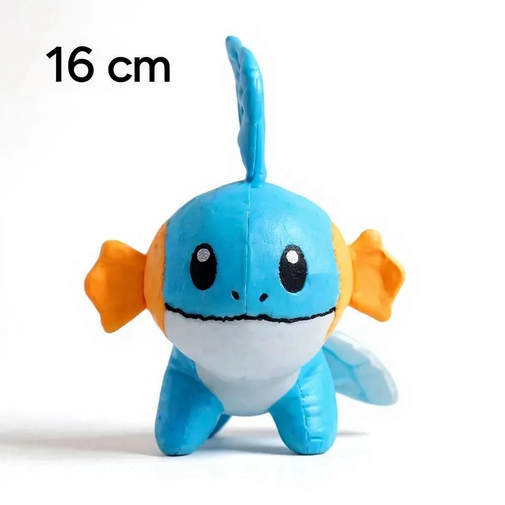 A plush toy of a Pokemon character, Mudkip, is shown standing on a white surface.