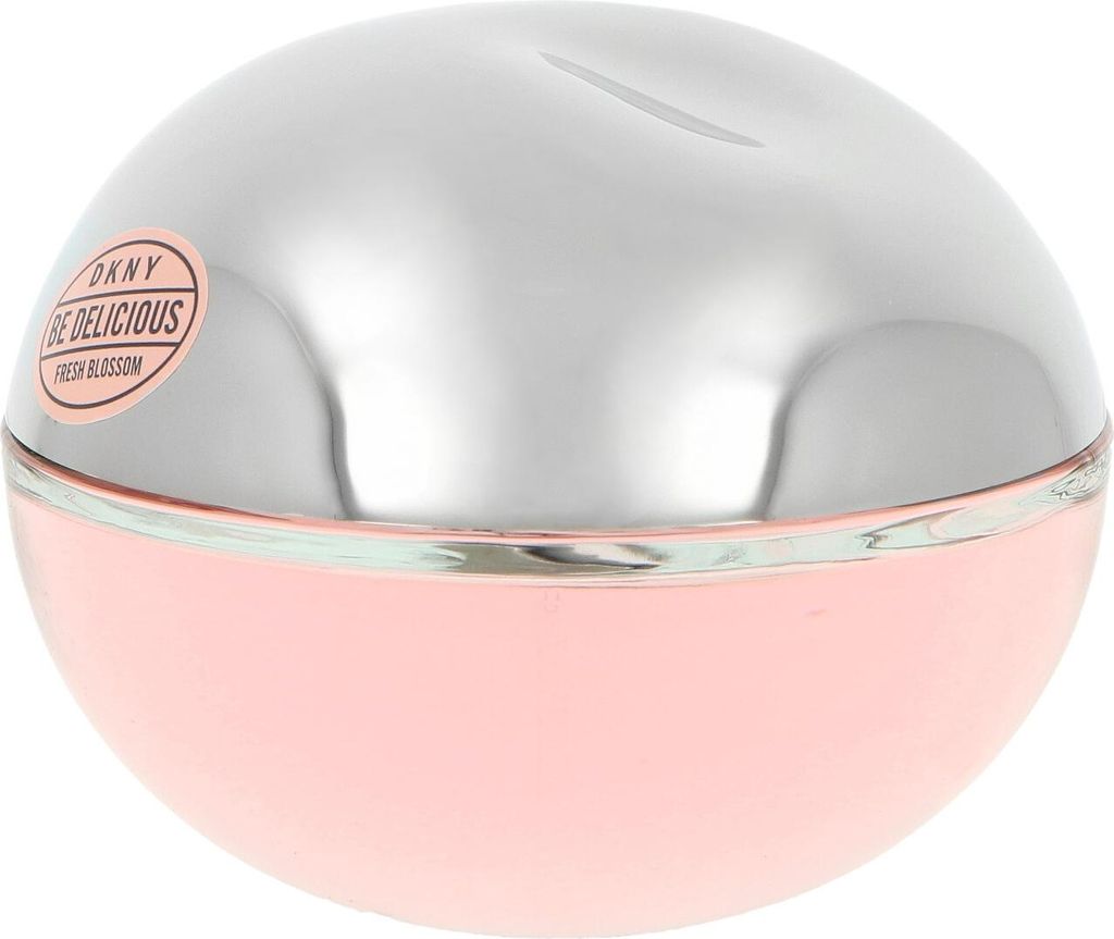 A close-up shot of a round, pink and silver perfume bottle.
