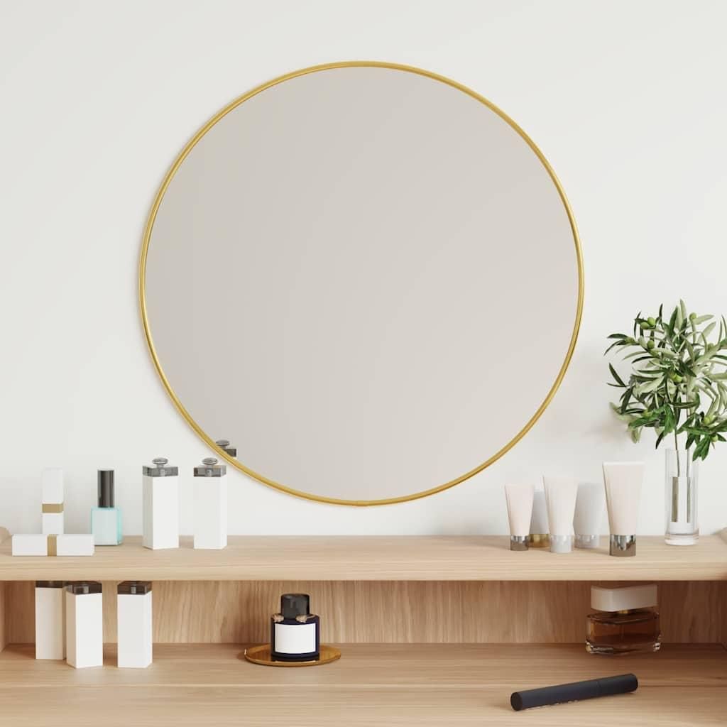 A round mirror with a gold frame is displayed on a wooden shelf, surrounded by various cosmetic products and a small plant.