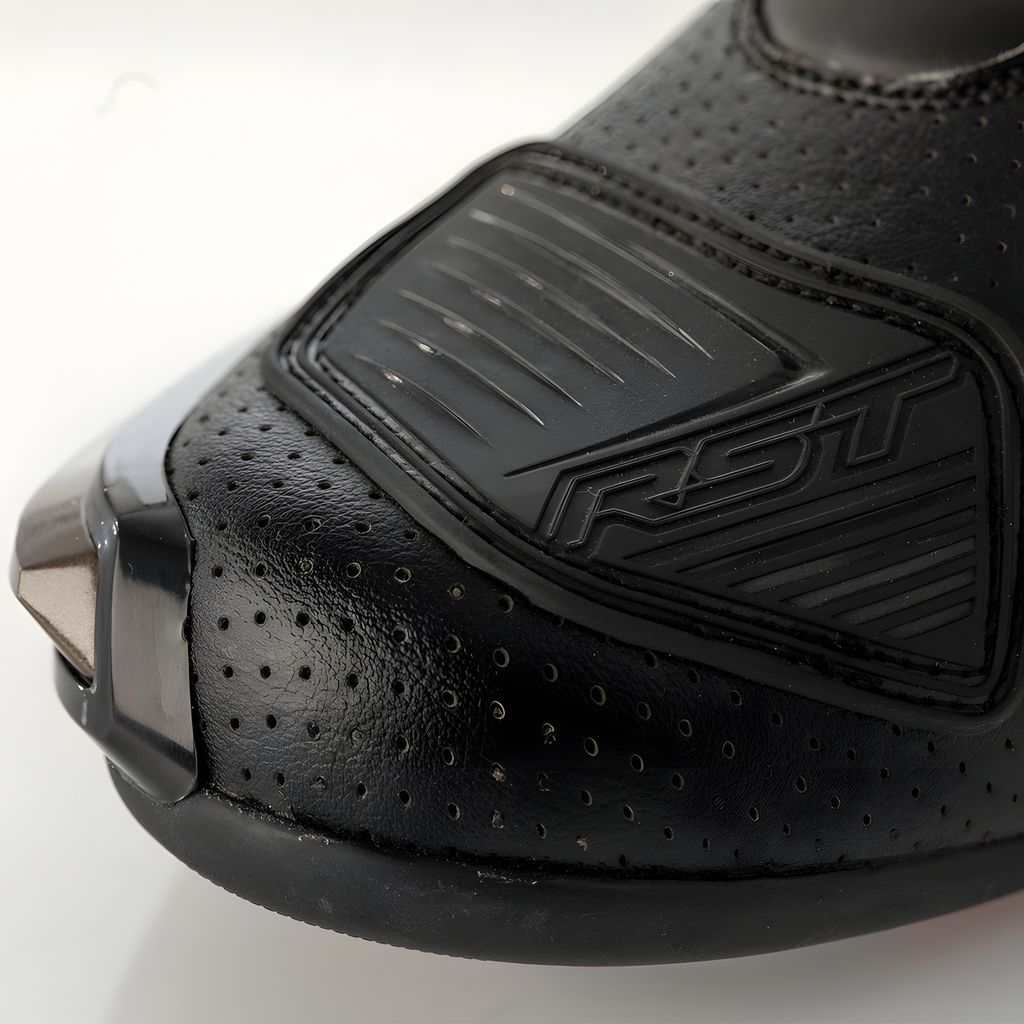 Close-up of the toe area of a black motorcycle boot.