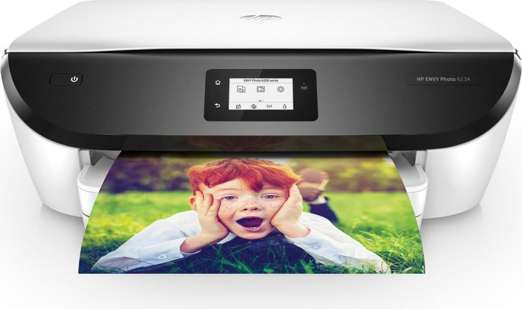 A white and black HP printer is printing a photo of a young boy.