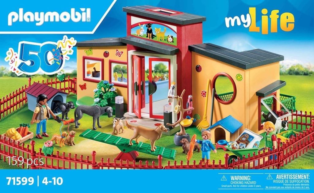 A Playmobil dog hotel playset is displayed on its packaging, showing various figures and accessories.