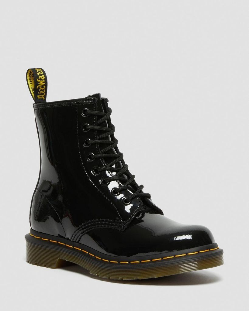 A black patent leather Dr. Martens boot is shown against a white background.