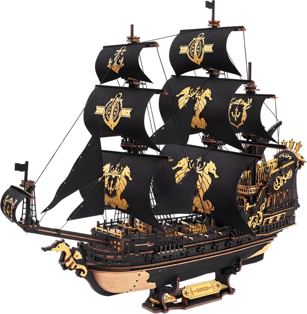 A detailed 3D wooden model of a pirate ship with black sails adorned with gold seahorse and anchor emblems, set against a white background.