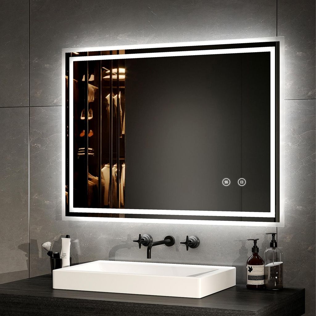 A modern bathroom vanity with a sink, faucet, and a large illuminated mirror.