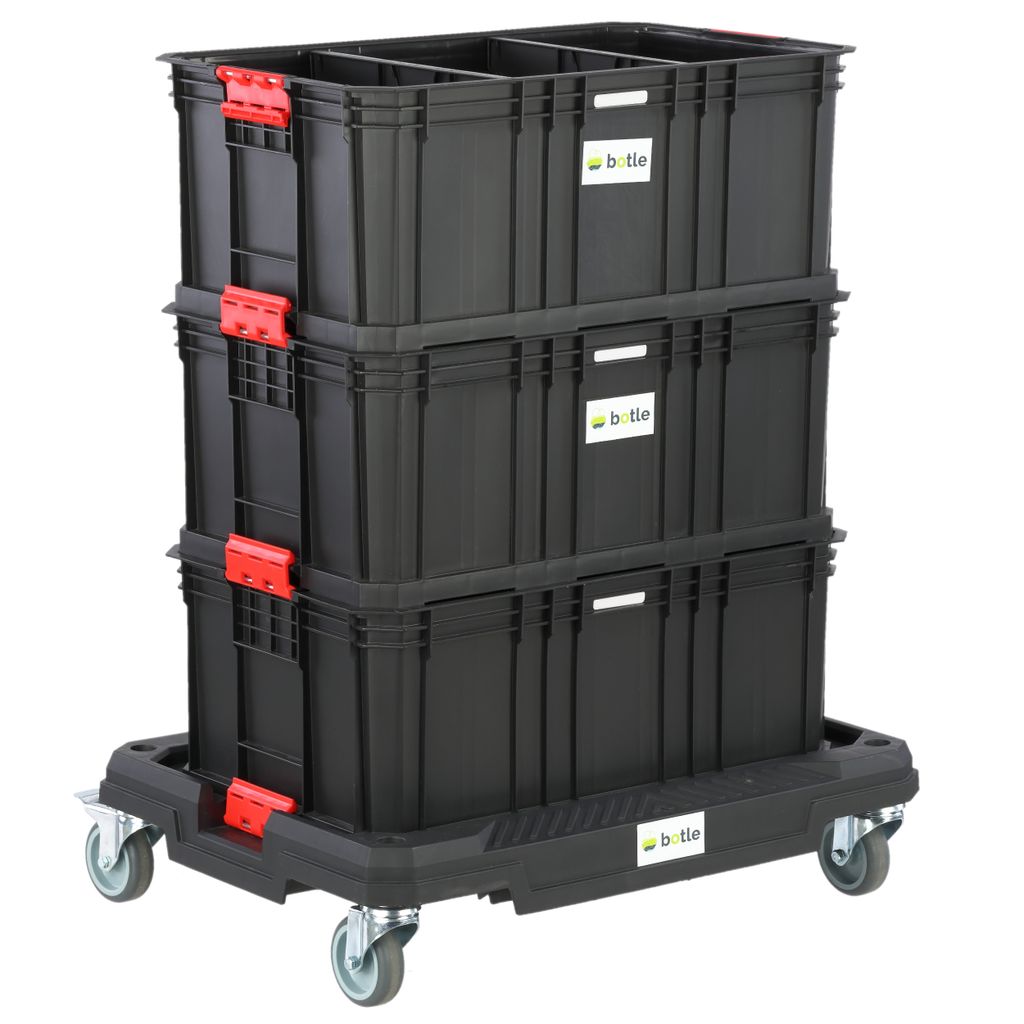 A stack of three black storage boxes with red latches on a black wheeled platform.