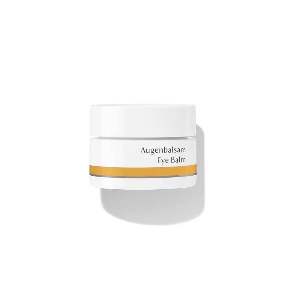 A product shot of an eye balm container on a white background.