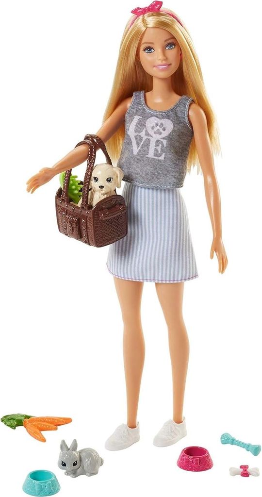 A Barbie doll holding a basket with a puppy and other pet accessories around her feet.