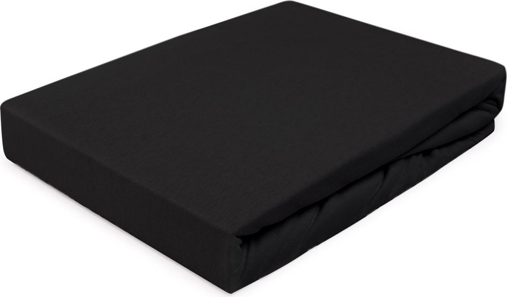 A black fitted sheet is folded and placed on a white surface.