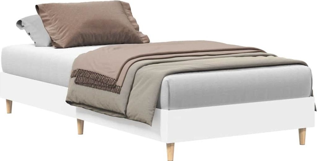 A white bed frame with bedding and pillows.