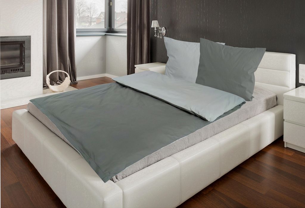 A bed with bedding laid out in a bedroom setting.