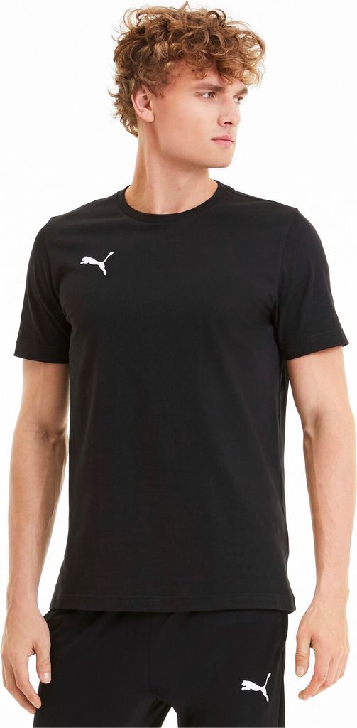 A man wearing a black Puma t-shirt and black shorts.