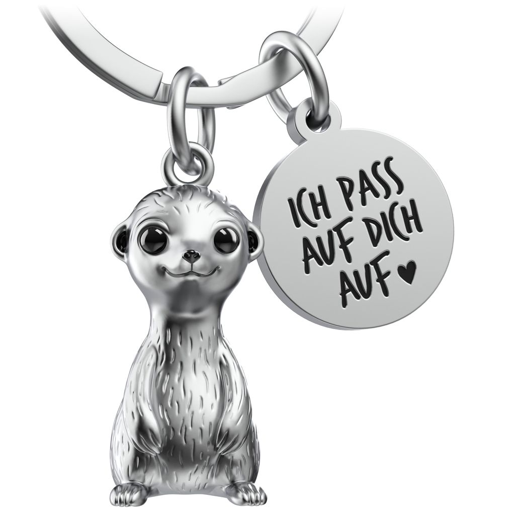 A silver meerkat keychain with a round charm engraved with text.