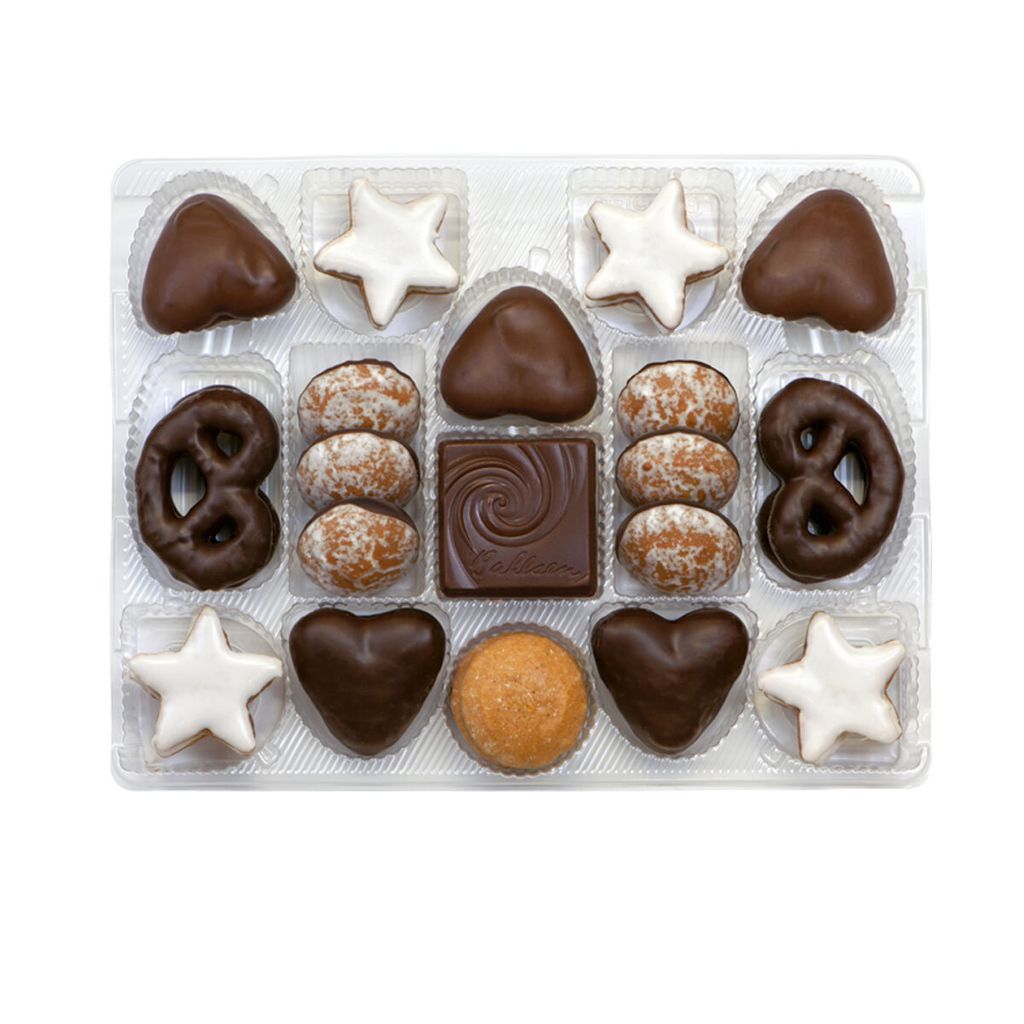 A clear, top-down view of a box of assorted Christmas cookies.