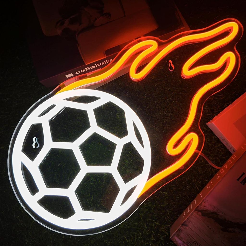 A neon LED light shaped like a soccer ball with flames, displayed on a dark, textured surface.