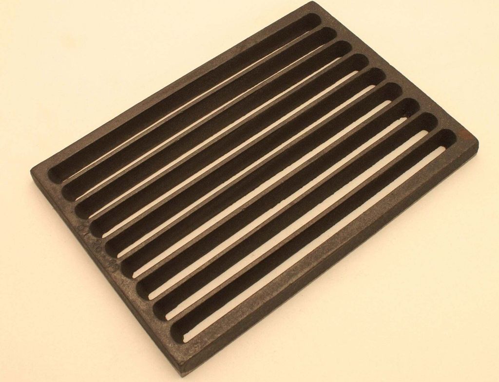 A dark gray cast iron grate with parallel raised bars on a light gray background.