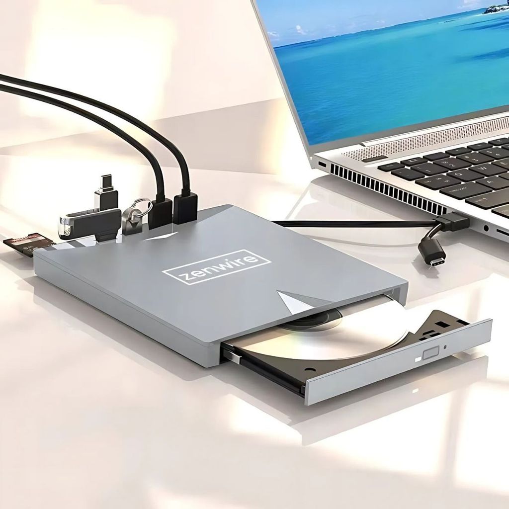A silver external DVD drive with a USB hub connected to a laptop.
