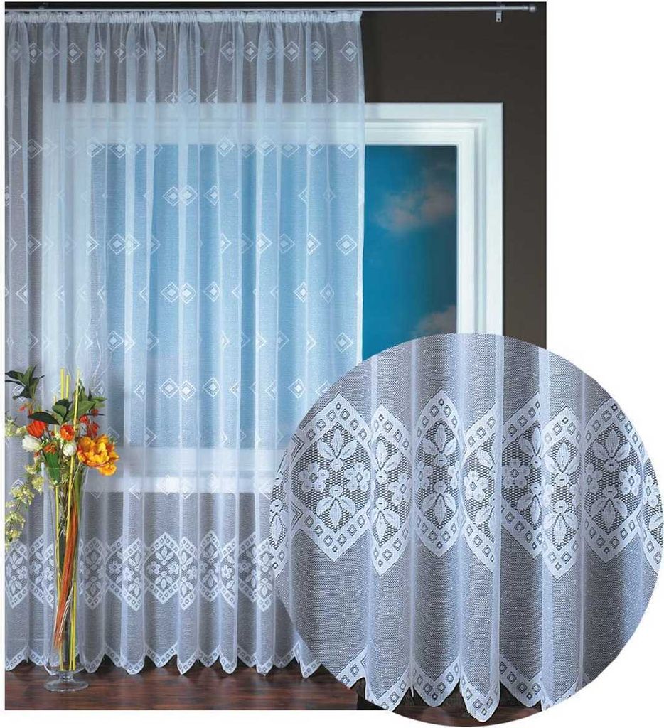 A white lace curtain with a floral pattern is displayed in front of a window.