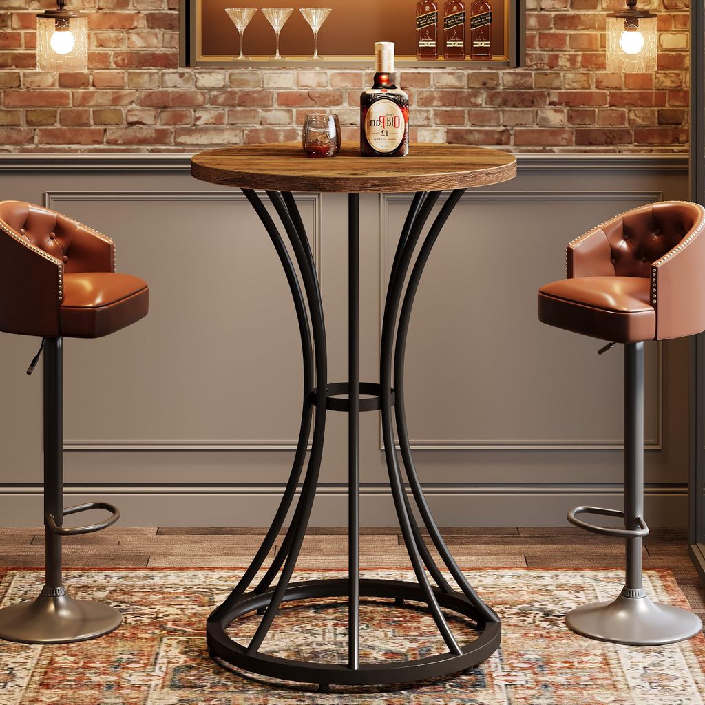 A bar area with a round table and two bar stools, featuring a bottle of liquor and a glass on the table.