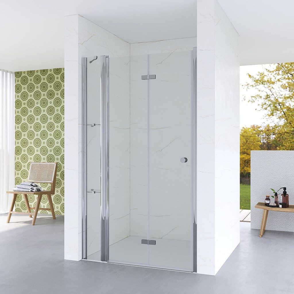 A modern bathroom with a glass shower enclosure, a chair with towels, and a patterned wallpaper.