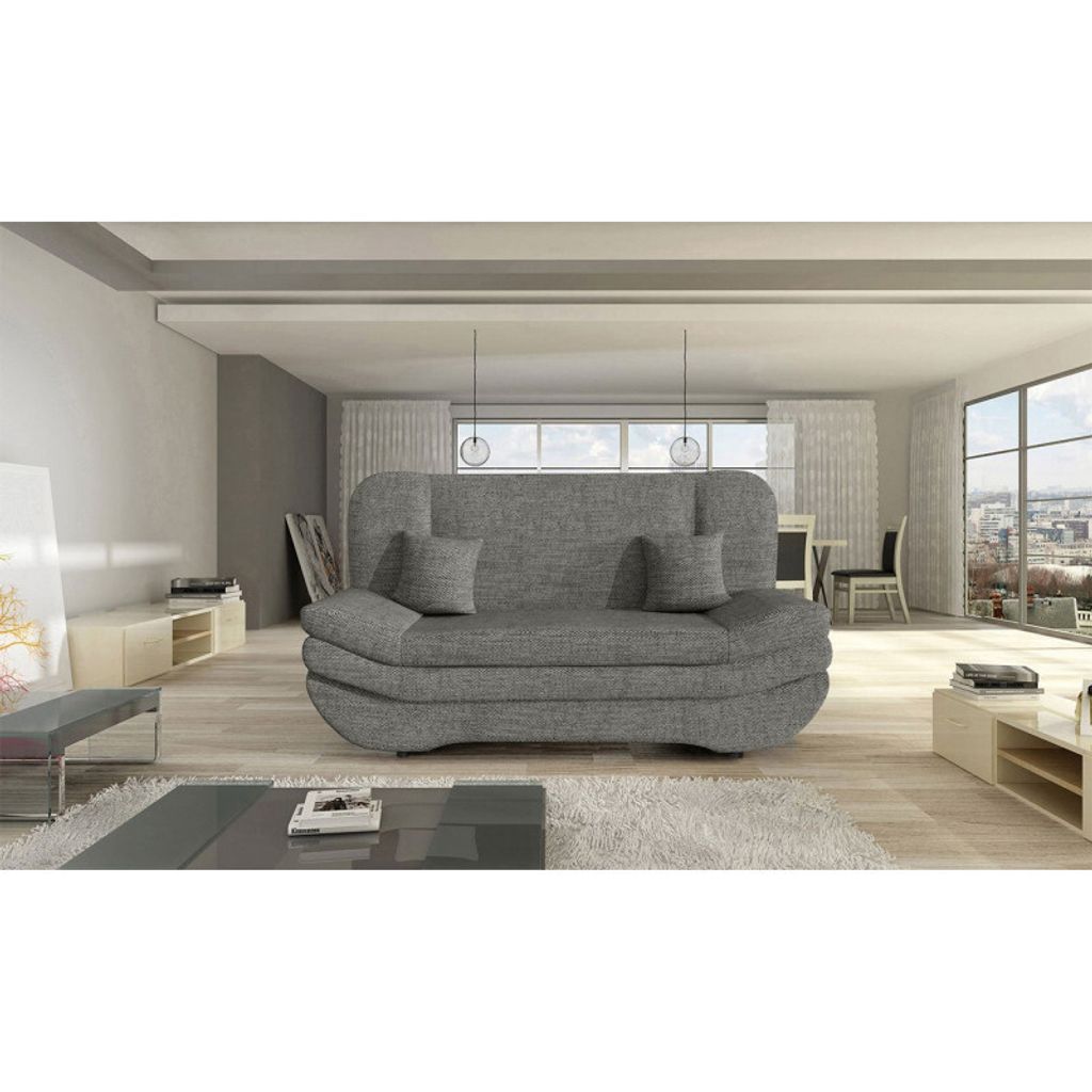 A modern living room with a gray sofa, coffee table, and large windows overlooking a city.