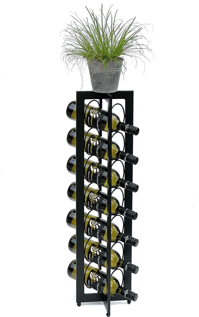 A black metal wine rack filled with wine bottles, topped with a potted plant.