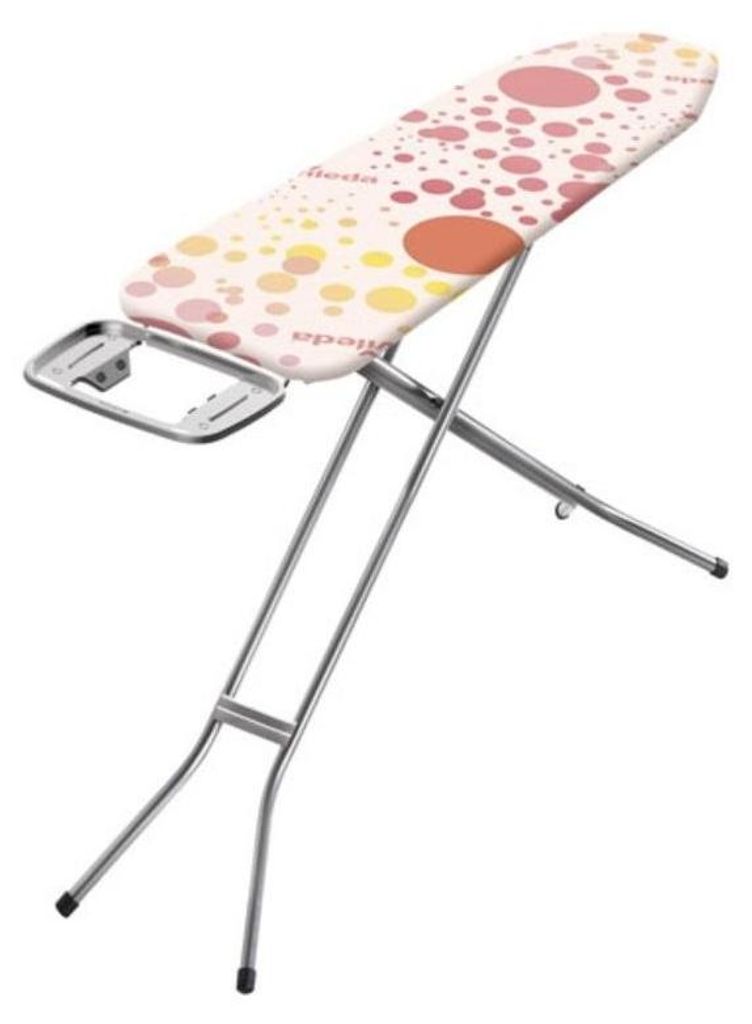 A pink and yellow polka dot ironing board with silver legs, shown from a slightly elevated angle.