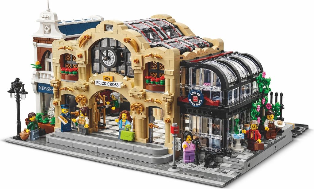 A LEGO model of a train station with people and accessories.