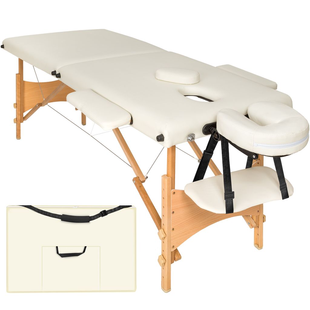 A cream-colored massage table with wooden legs and a carrying case.