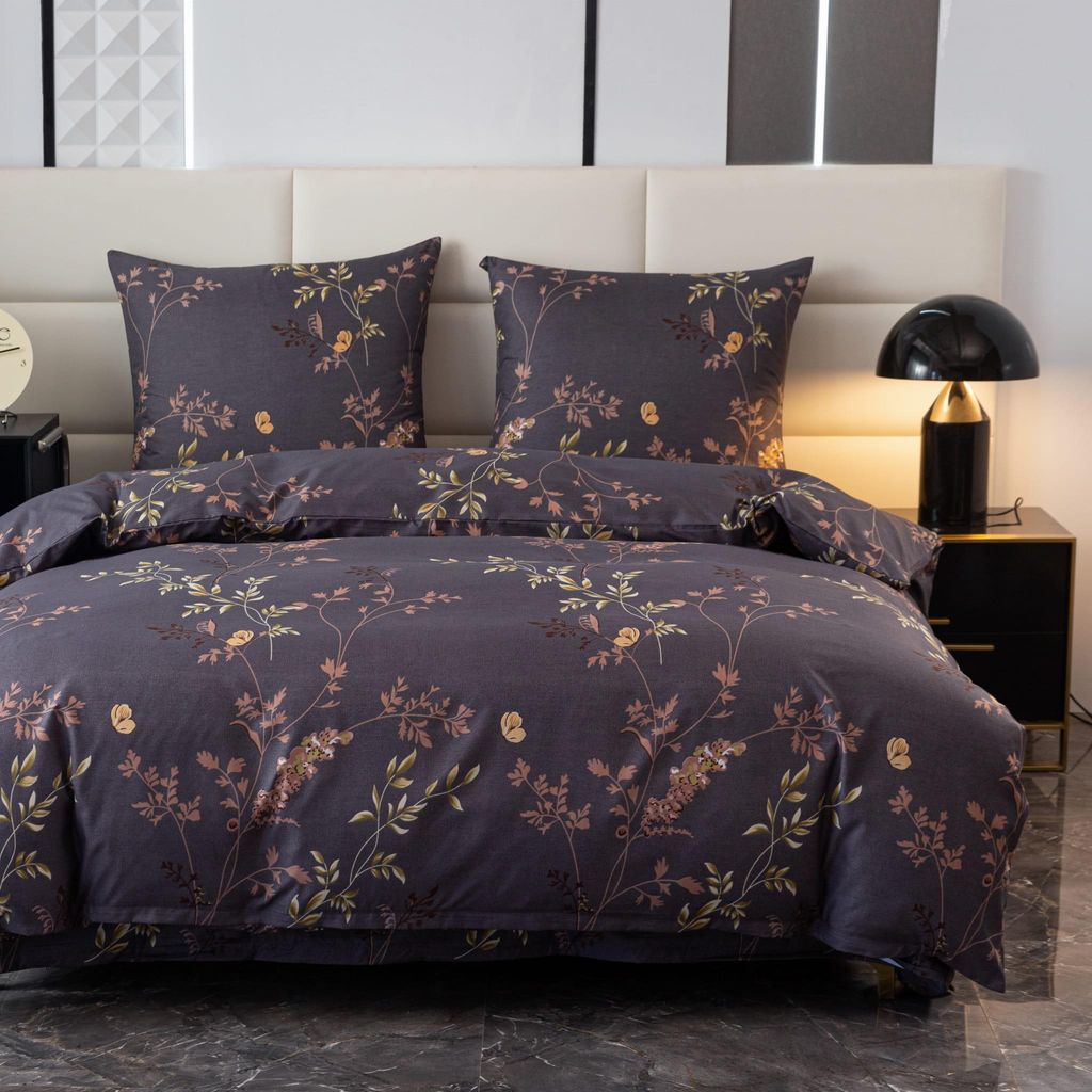 A close-up view of a floral patterned duvet and pillow set on a bed.