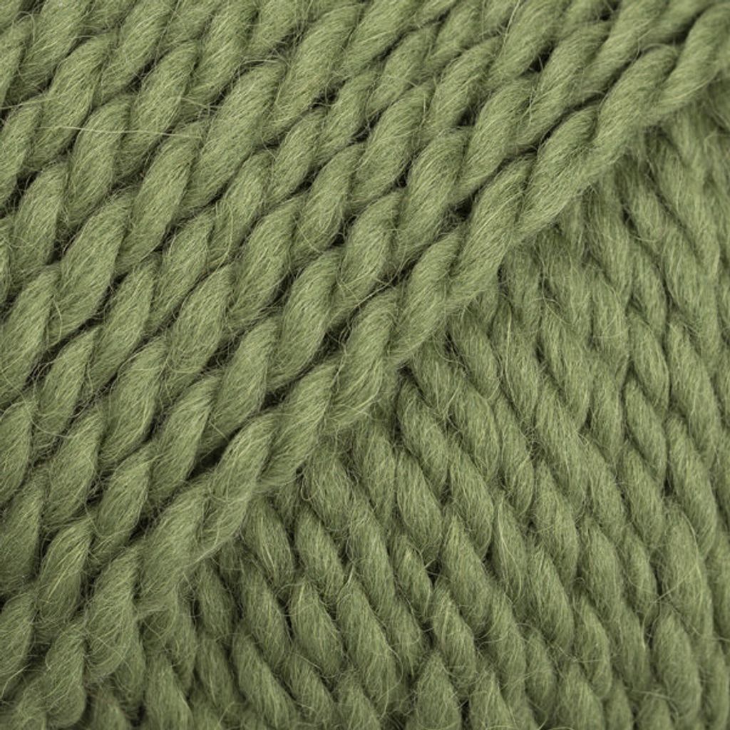 A close-up, textured view of green yarn.