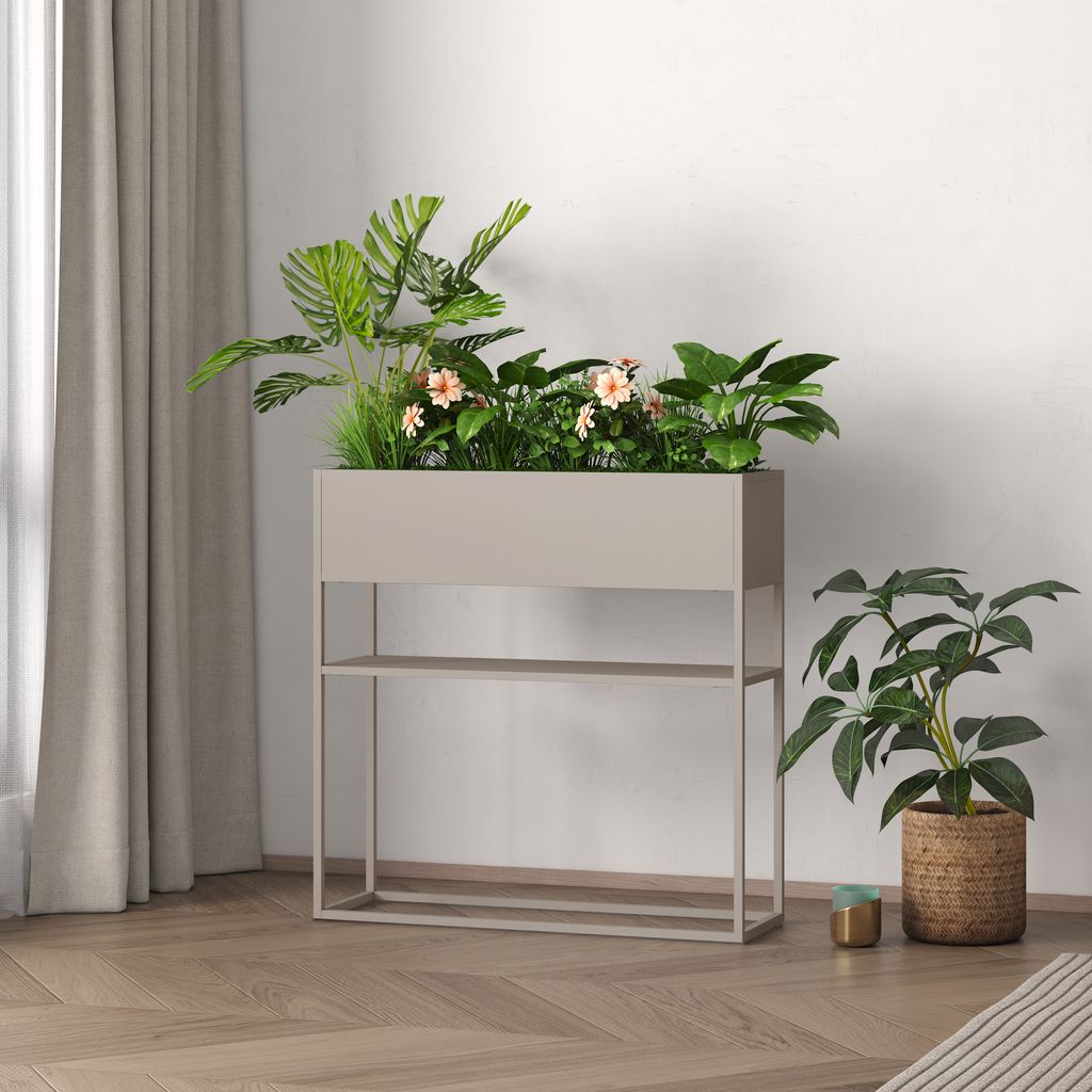 A planter with plants and flowers on a stand, next to a potted plant, in a room with curtains and wooden flooring.
