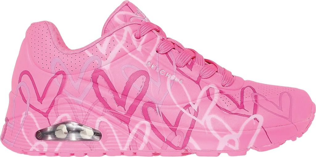 A side view of a pink sneaker with a heart pattern.