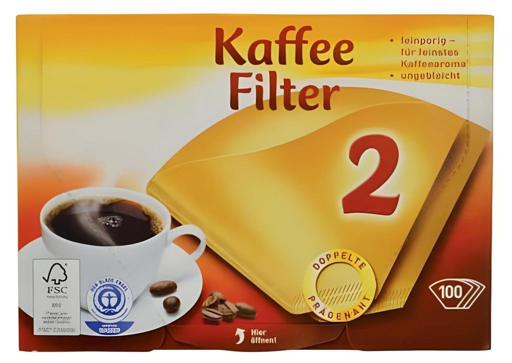 A box of coffee filters with a cup of coffee and coffee beans.