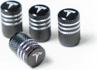 Čierne ventilové viečka s logom Tesly