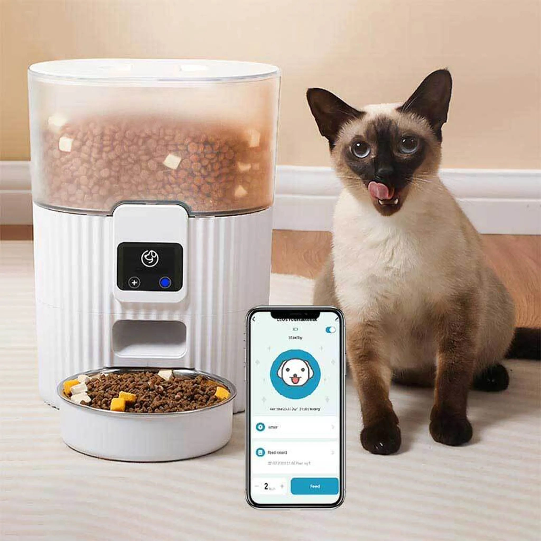 Cat beside an automatic smart pet feeder with a phone used for feeding controls