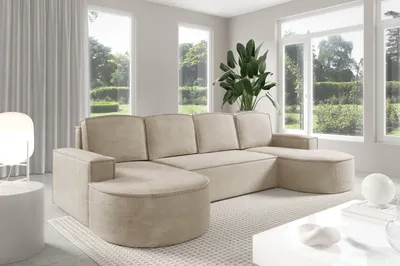A modern living room with a large sectional sofa and large windows.